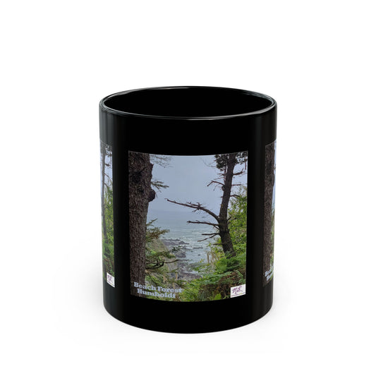 Black Mug 11oz - "Beach Forest Humboldt(tm)" - MiE Designs Shop. Sitka Spuce flank a trailhead leading down to rocky coastline below. Front of mug