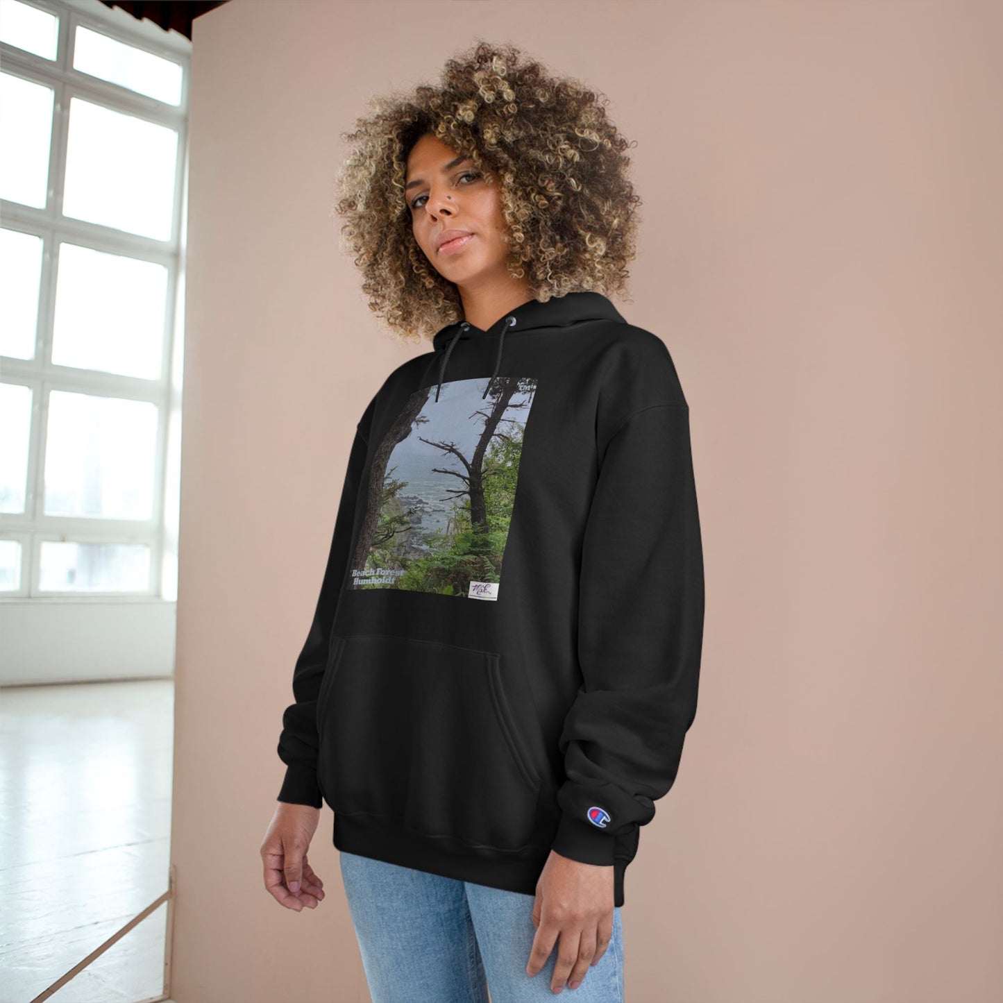 Champion Hoodie - "Beach Forest Humboldt(tm)" - Dark Green - MiE Designs Shop. Sitka Spuce flank a trailhead leading down to rocky coastline below. Model pose