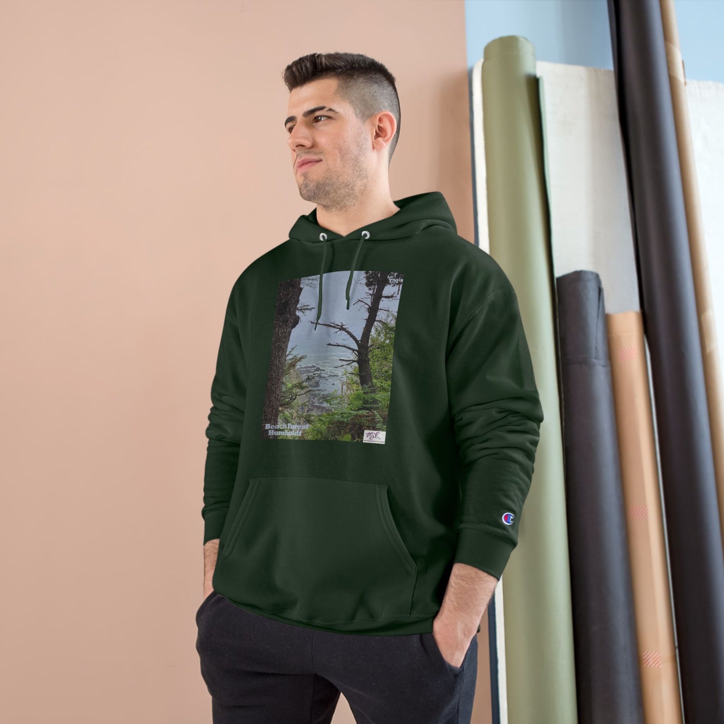 Champion Hoodie - "Beach Forest Humboldt(tm)" - Black - MiE Designs Shop. Sitka Spuce flank a trailhead leading down to rocky coastline below. Model pose