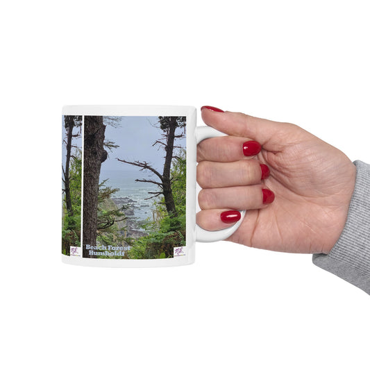 Ceramic Mug 11oz - "Beach Forest Humboldt(tm)" - MiE Designs Shop. Sitka Spuce flank a trailhead leading down to rocky coastline below. Mug in hand