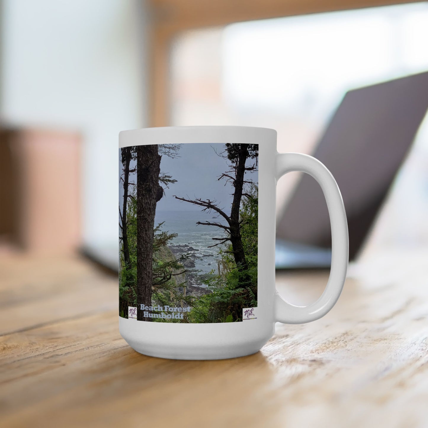 Ceramic Mug 15oz - "Beach Forest Humboldt(tm)" - MiE Designs Shop. Sitka Spuce flank a trailhead leading down to rocky coastline below. On desk